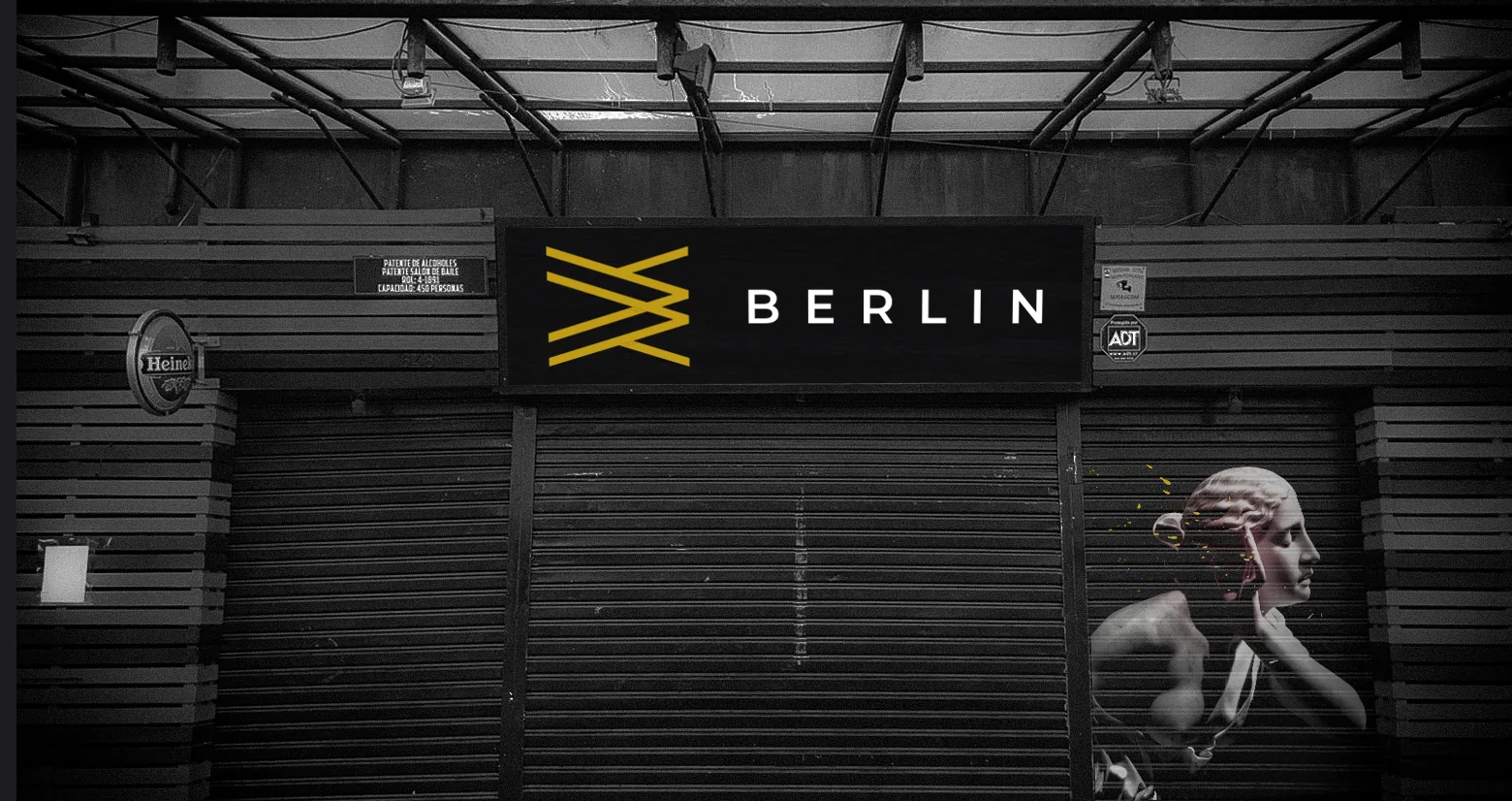 Berlin Club storefront with the yellow Berlin mark on a black lightbox sign